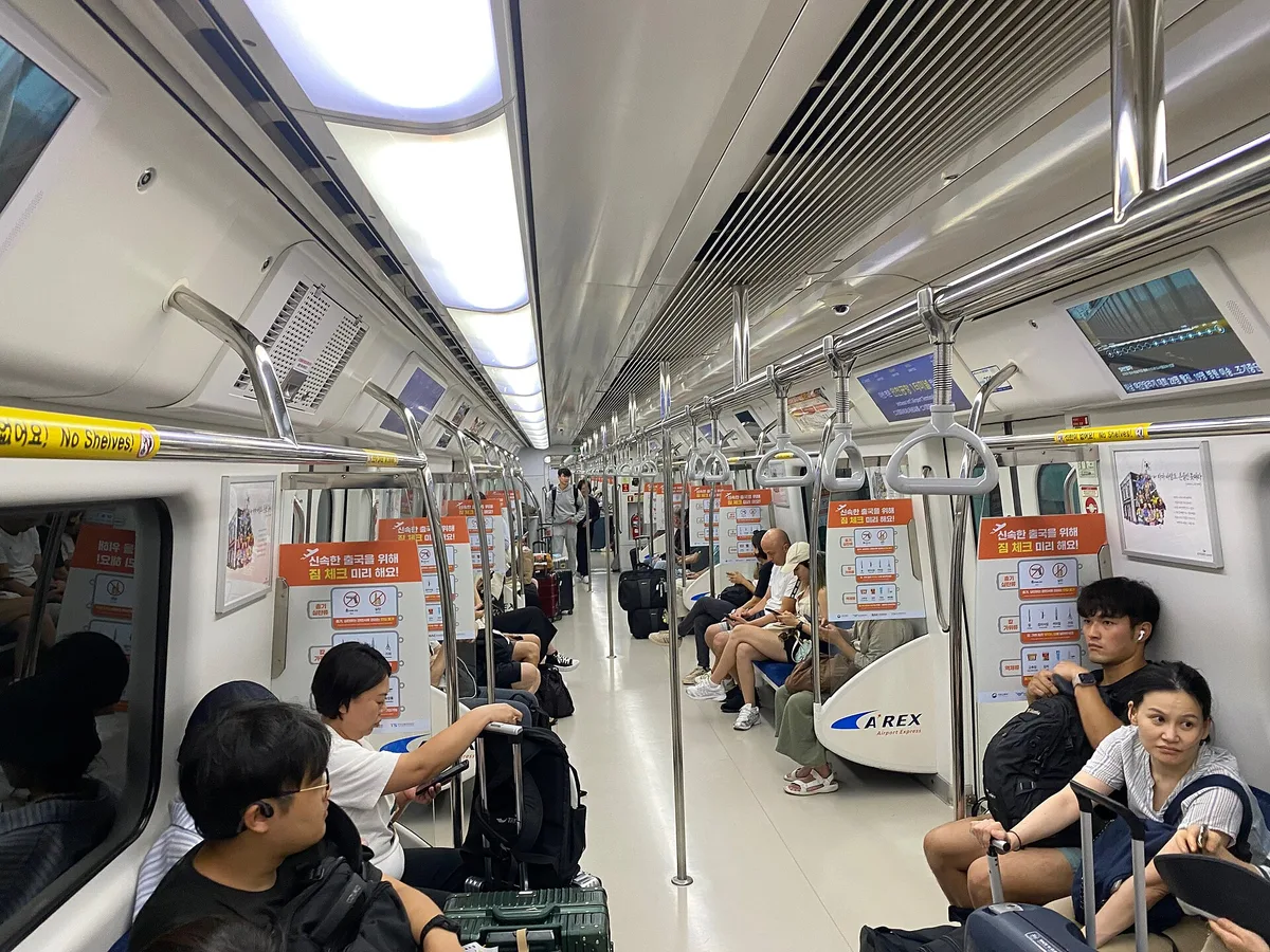 A Seoul metro platform with passengers waiting, Seoul, South Korea